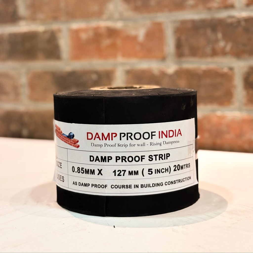 Roll of damp proof strip with 'Damp Proof India' branding against a brick wall background.